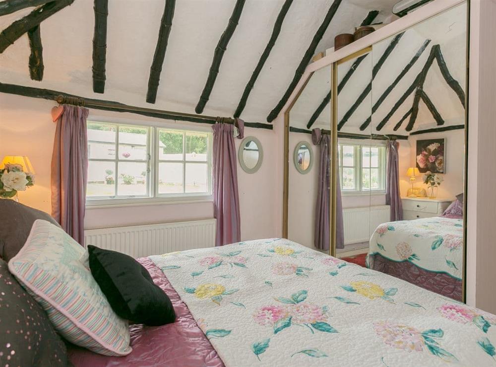 Ample built-in storage and exposed wooden framework with the double bedroom at Brittons Hill Cottage in Kenardington, near Ashford, Kent