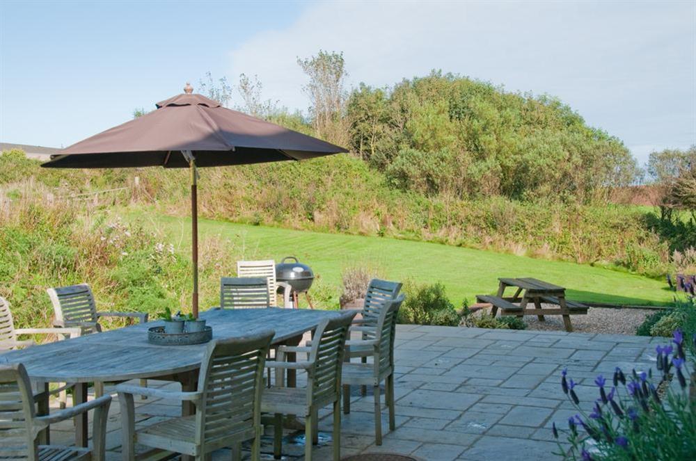 Large terrace with table and chairs, iodeal for al fresco entertaining at Broad Downs Barn in Malborough, Nr Salcombe