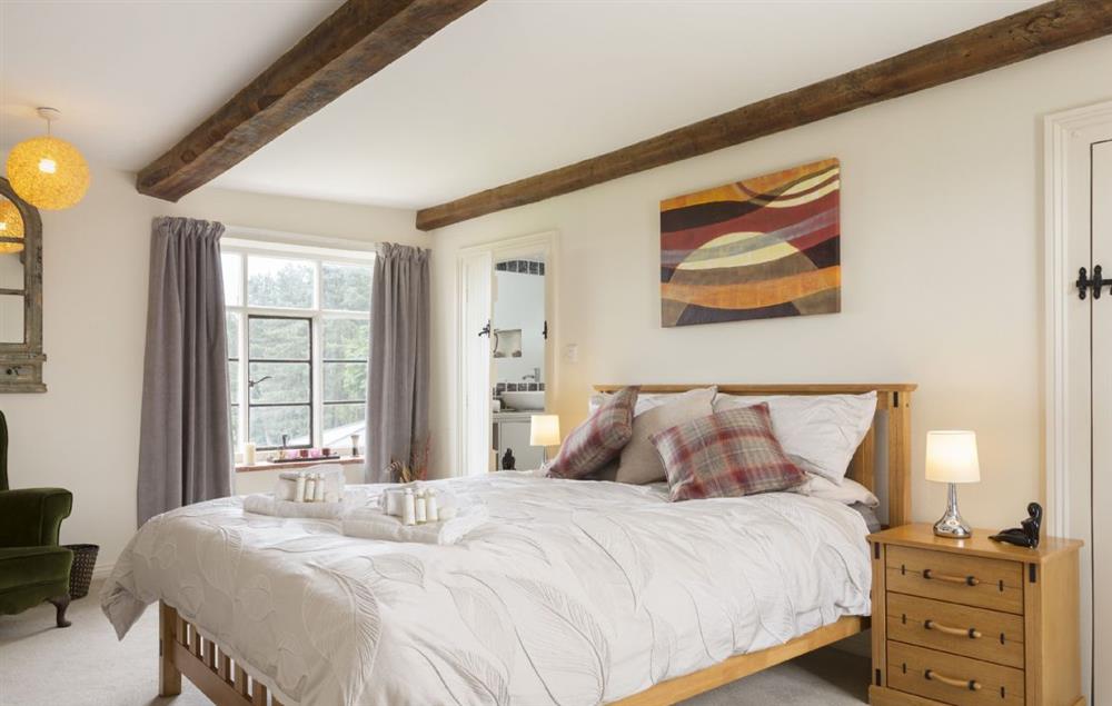 Bedroom with 5’ king size bed and en-suite shower room at Broad Meadows Farmhouse, Bayton