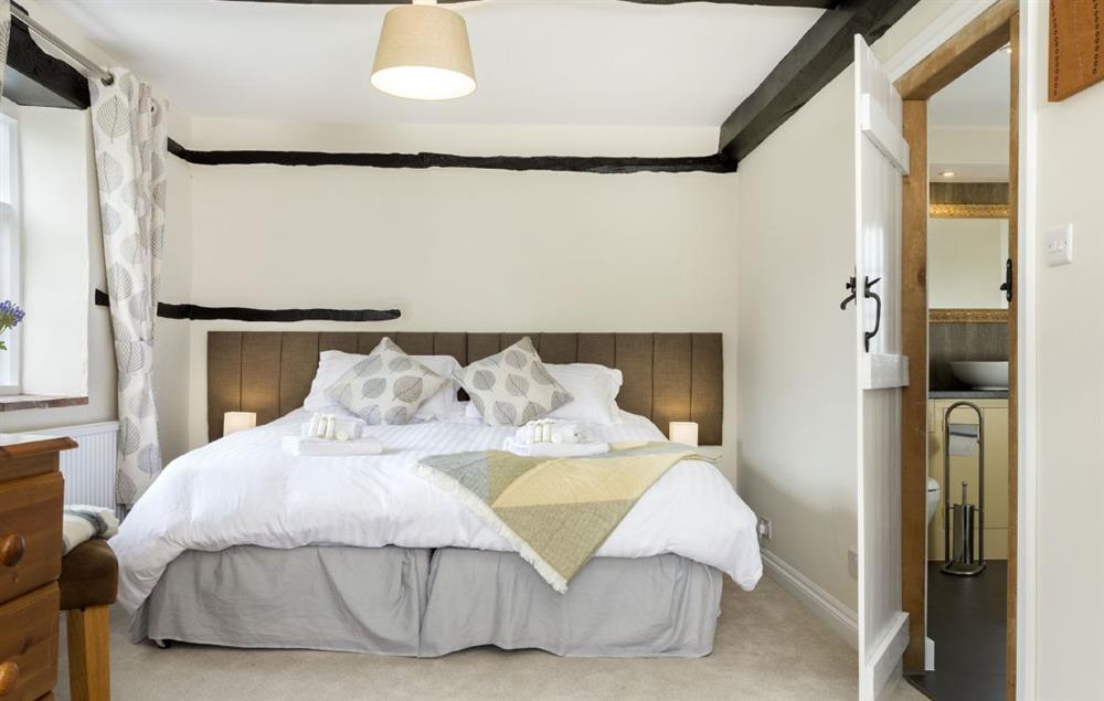 Bedroom with 6’ super king zip and link bed and en-suite bathroom at Broad Meadows Farmhouse, Bayton