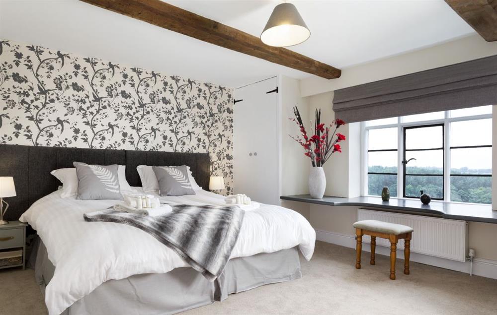 Bedroom with 6’ super king zip and link bed and en-suite shower room at Broad Meadows Farmhouse, Bayton