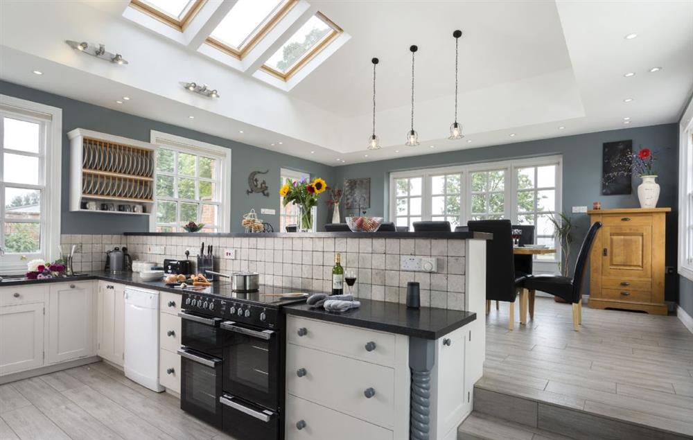 Fully equipped kitchen and dining room with french doors that lead out into the garden at Broad Meadows Farmhouse, Bayton