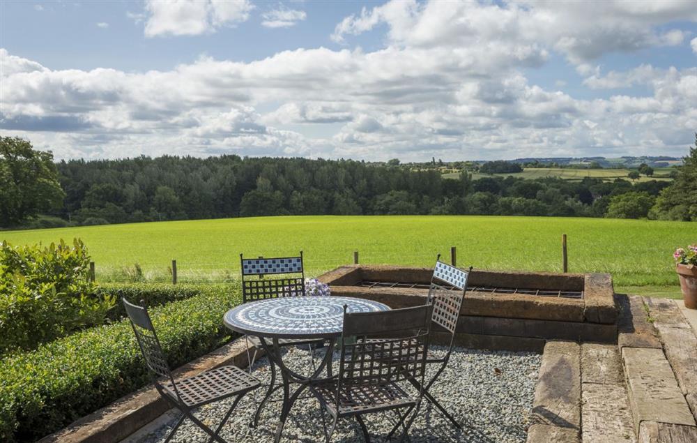 Seating area with stunning countryside views at Broad Meadows Farmhouse, Bayton