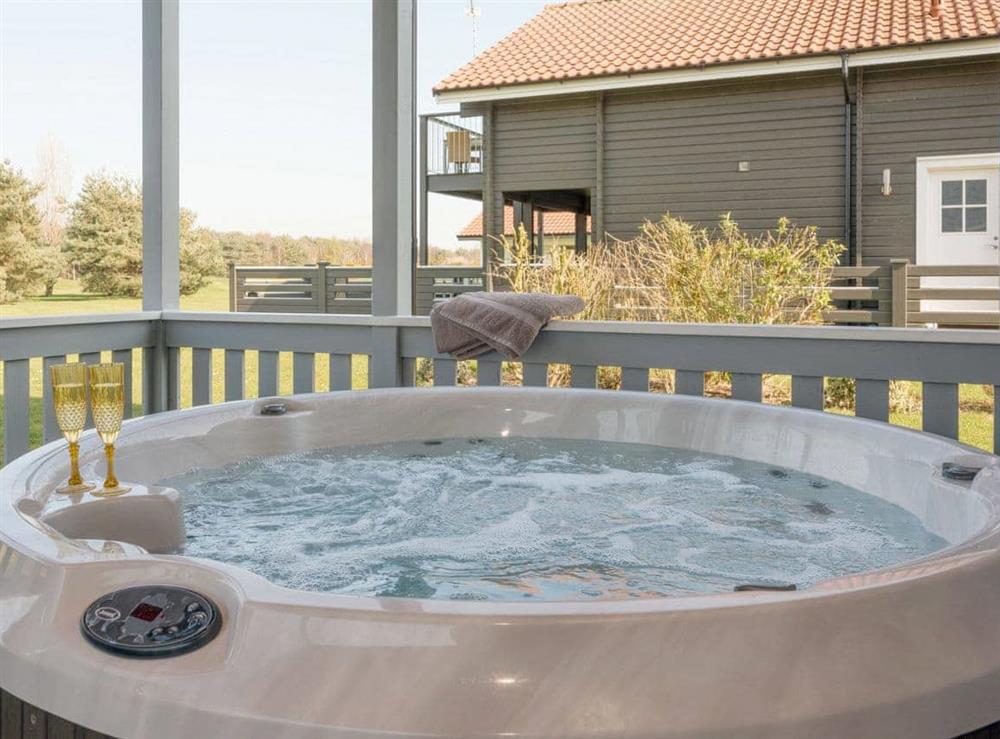 Luxurious hot tub on covered deck at Broad Reach in Fritton, near Great Yarmouth, Norfolk