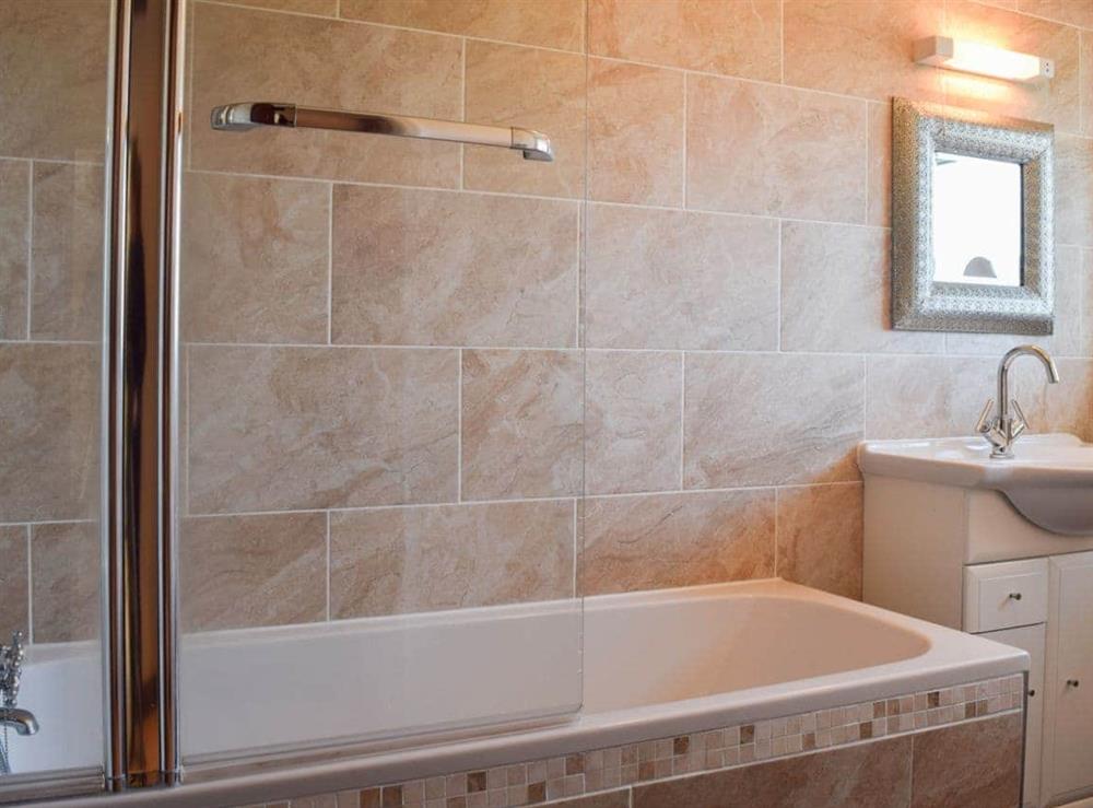 Tiled bathroom with shower over the bath at Broadmeadows Farm in Butterton, Staffordshire., Great Britain