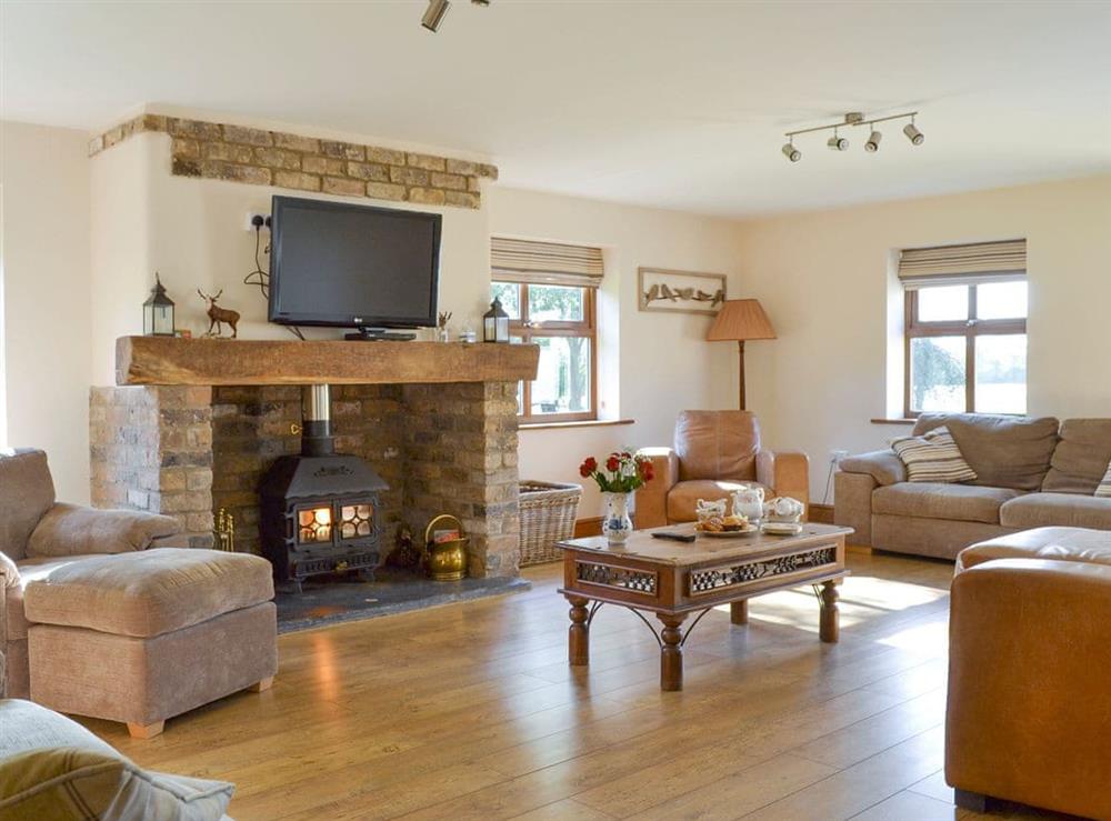 Spacious living room with wood burner at Barley Edge, 
