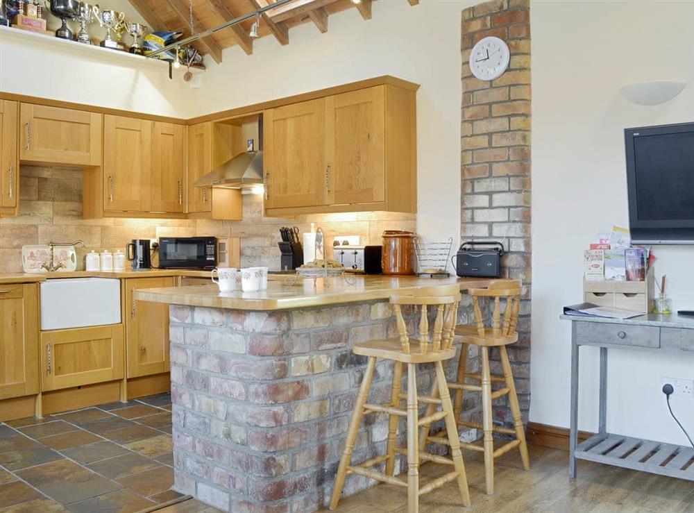 Well-equipped fitted kitchen with breakfast bar at Barley Edge, 
