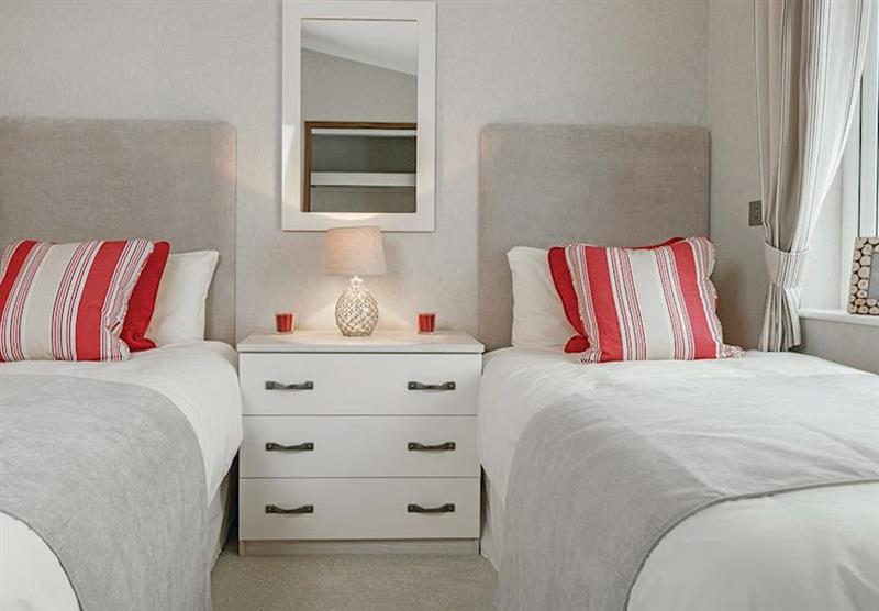 A bedroom in the Country Lodge Four VIP Platinum at Brokerswood Holiday Park in Southwick, Wiltshire
