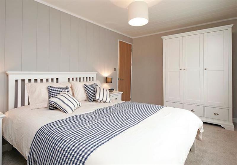 Double bedroom in a Country Lodge Six VIP Platinum at Brokerswood Holiday Park in Southwick, Wiltshire