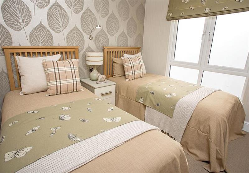 Twin bedroom in a Country Lodge Four VIP Platinum at Brokerswood Holiday Park in Southwick, Wiltshire