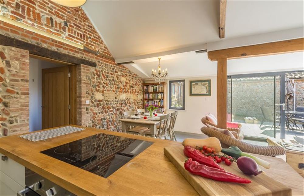 Ground floor:  Central island with electric oven and separate hob at Bromholm Barn, Ridlington near Norwich