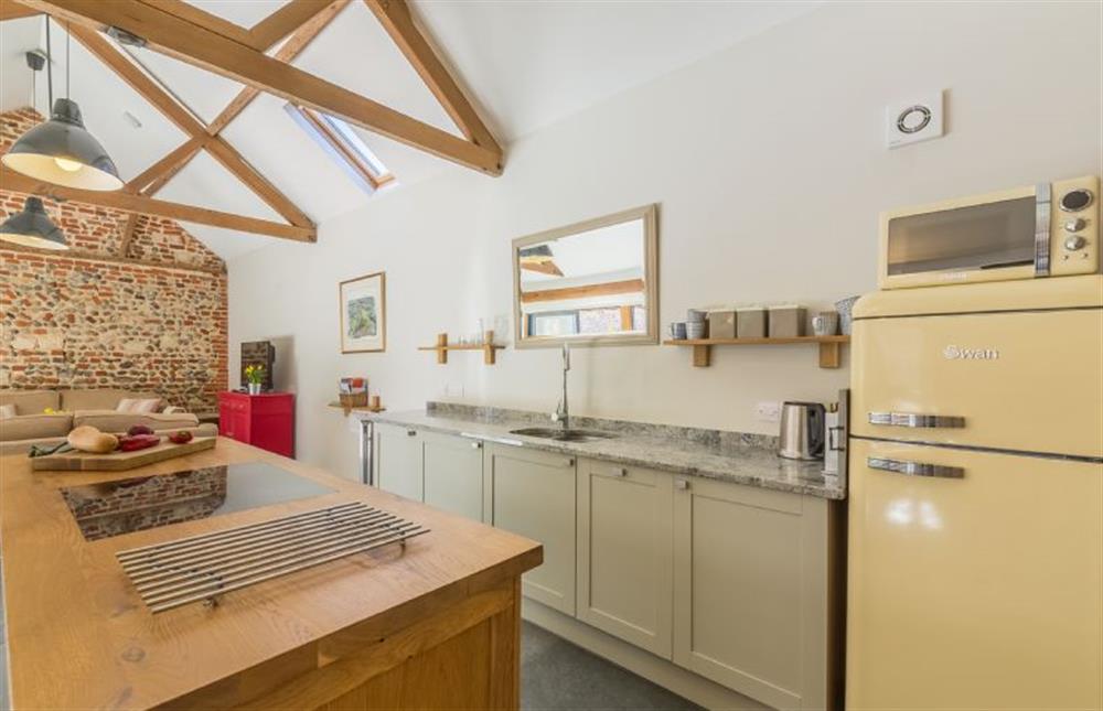 Ground floor:  Kitchen area with central island at Bromholm Barn, Ridlington near Norwich