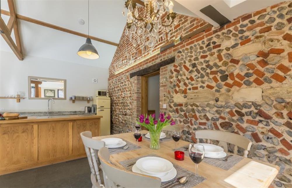 Ground floor:  Kitchen/dining area with feature exposed brick wall at Bromholm Barn, Ridlington near Norwich