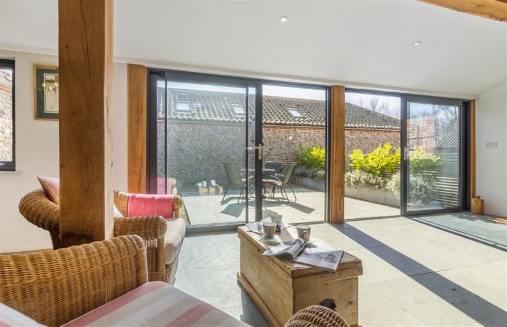 Ground floor:  Open plan living area with sliding glass doors to courtyard at Bromholm Barn, Ridlington near Norwich