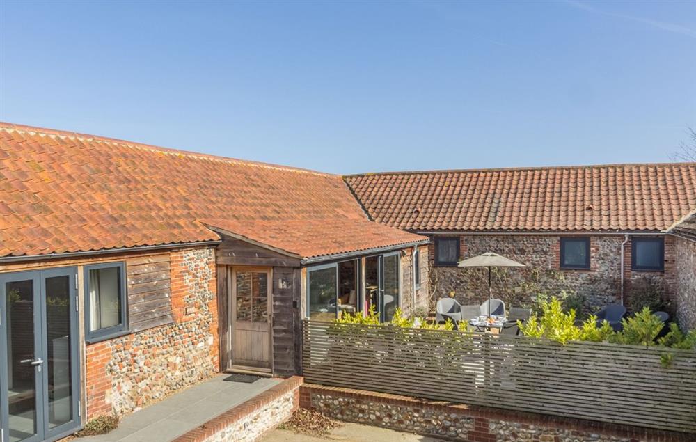 Private and secure south/west facing courtyard with patio at Bromholm Barn, Ridlington
