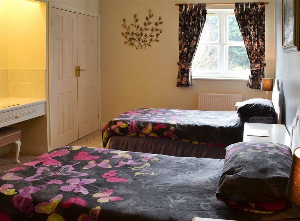 Twin bedded room with large wardrobes and vanitory unit