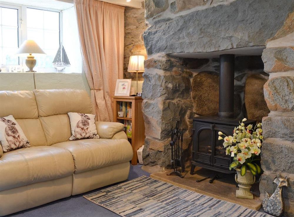 Living room with wood burner at Bron Gybi in Llangybi, near Pwllheli, Gwynedd
