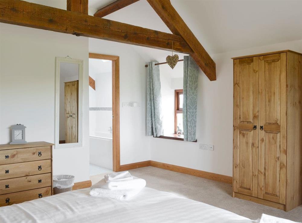 Exposed wood beams in double bedroom at Llofft Storws, 