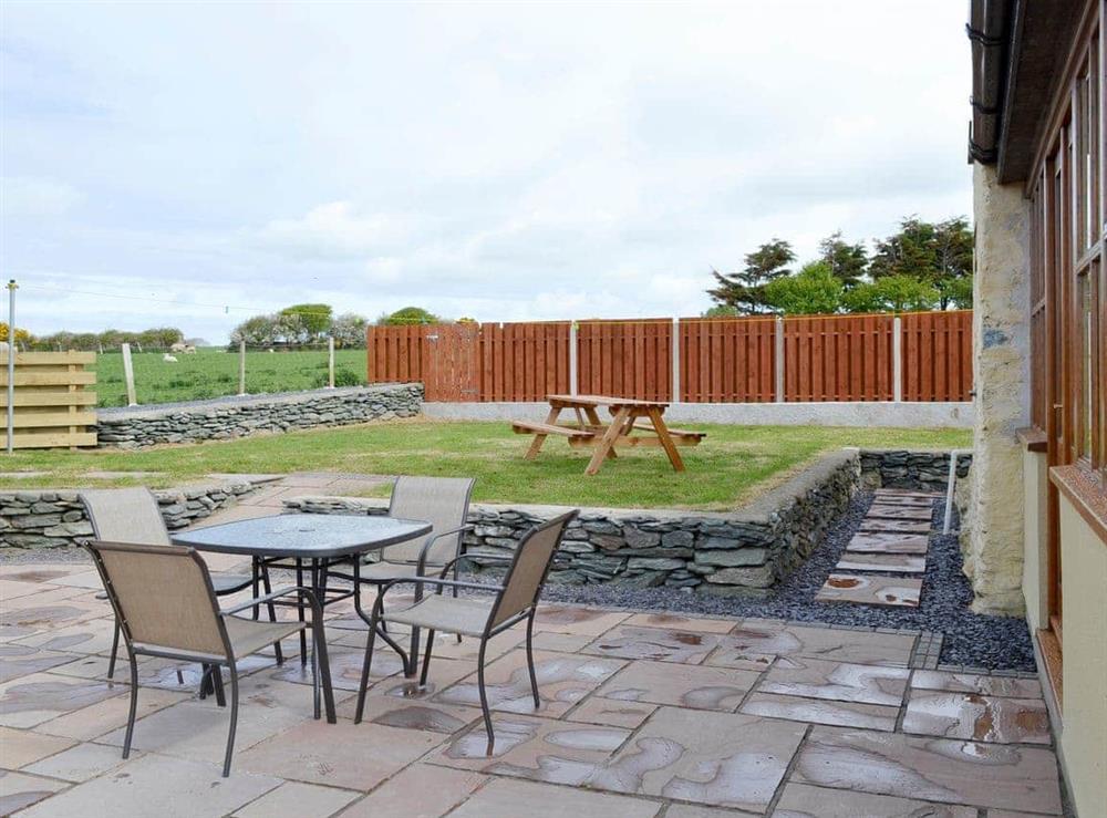 Patio with outdoor furniture at Llofft Storws, 