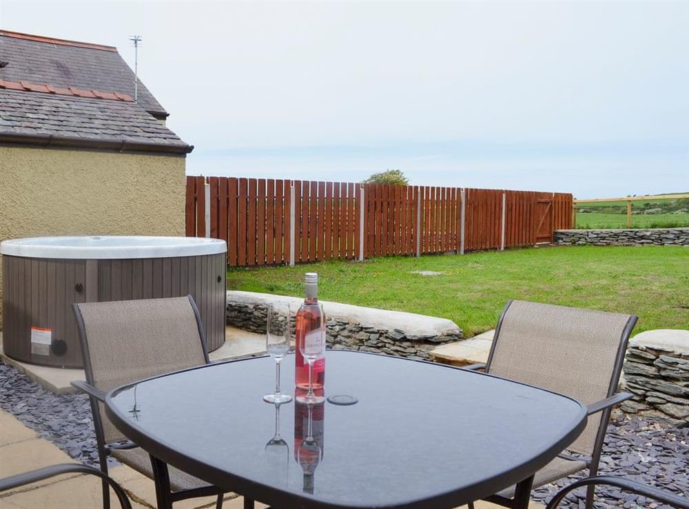 Enclosed lawned garden with patio, garden furniture and private hot tub. at Yr Hen Feudy, 