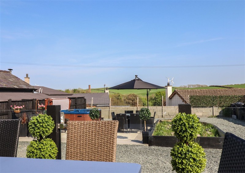 Enjoy a glass of wine on the patio at Bronallt, Cemaes Bay