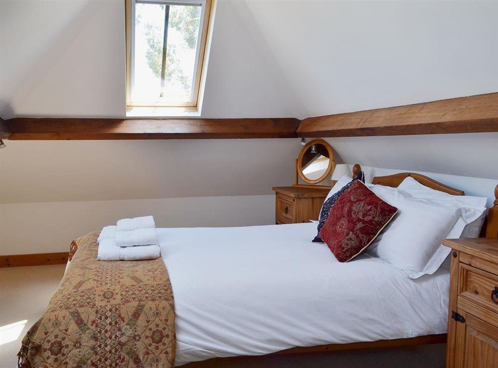 The first floor double bedroom has sloping ceilings and roof windows at Brook Barn in Shobley, Ringwood, Hants., Hampshire