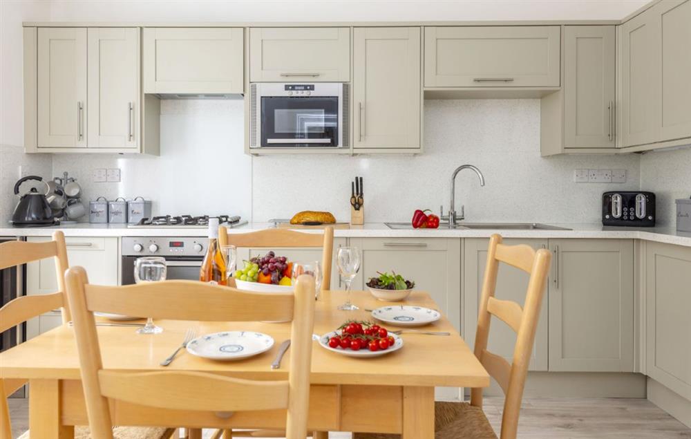 Fully equipped kitchen with dining table at Brook Cottage (Cornwall), Trevose Head Lighthouse