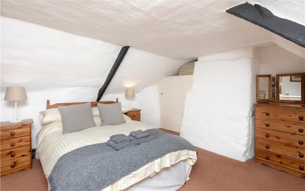 Double bed in the bedroom  at Brook Cottage in Hope Cove