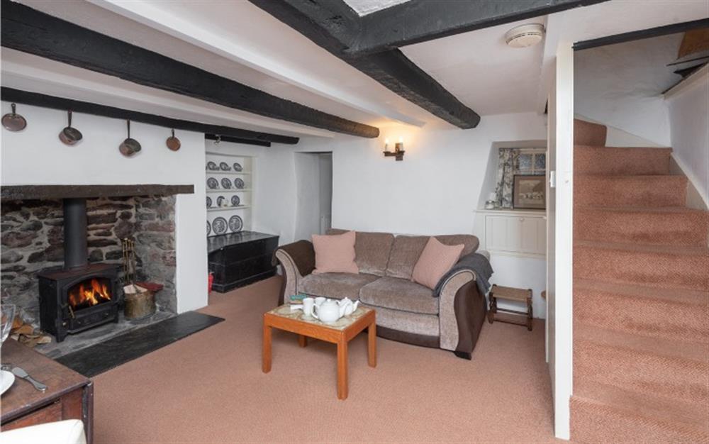 Lounge with log burner at Brook Cottage in Hope Cove