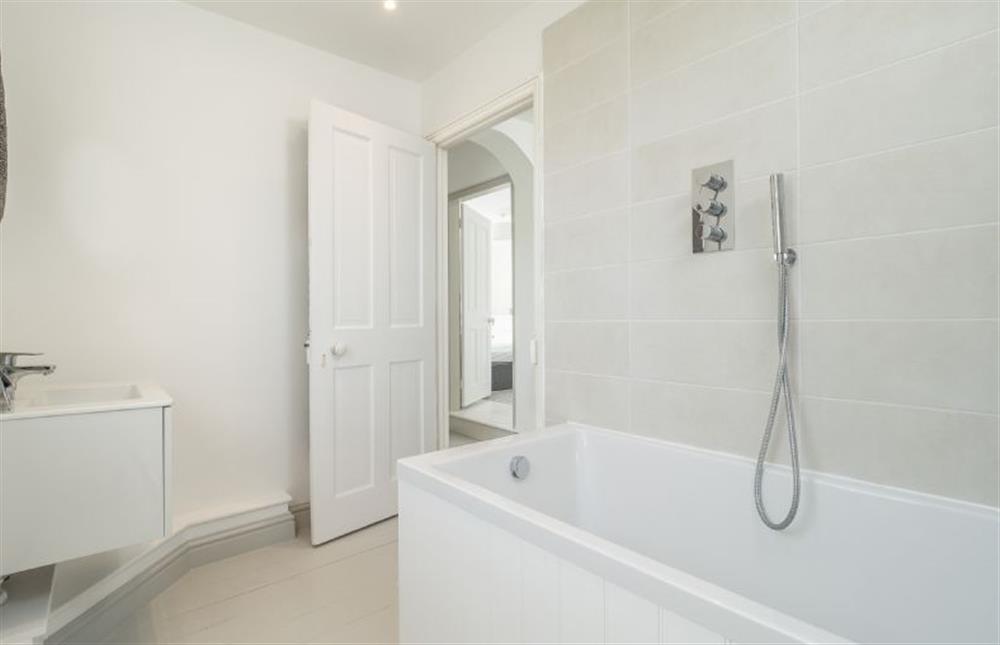 First floor: Family bathroom has bath and handheld shower (photo 2) at Brook House, Brinton near Melton Constable