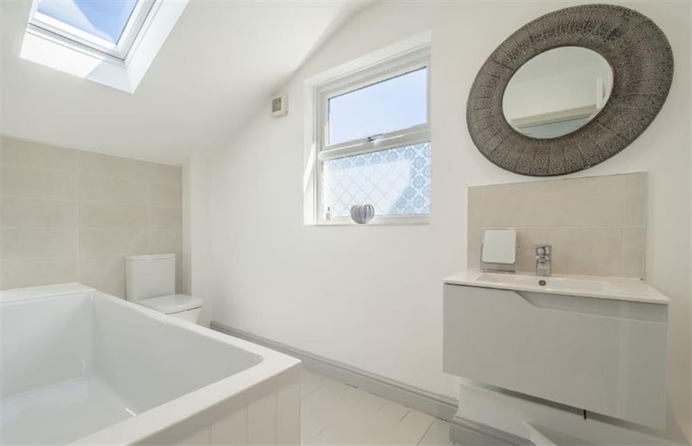 First floor: Family bathroom has bath and handheld shower at Brook House, Brinton near Melton Constable