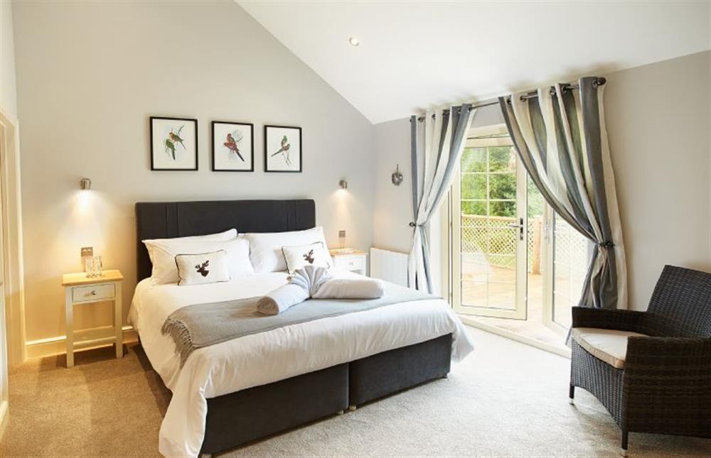 Master bedroom with 6’ bed and en-suite bathroom with separate shower at Brook Lodge, Colne Valley