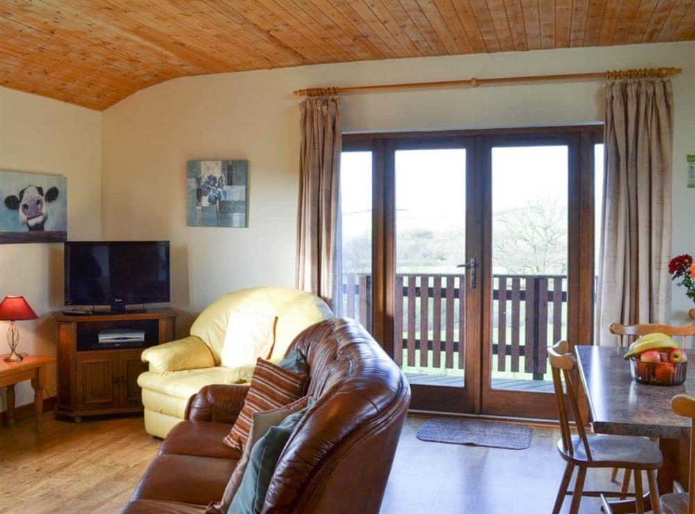 Living area with french doors to verandah at Brook View in Llandrindod Wells, Powys