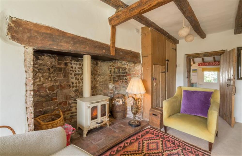 Ground floor: Sitting room with wood burning stove at Brooke Cottage, Great Walsingham