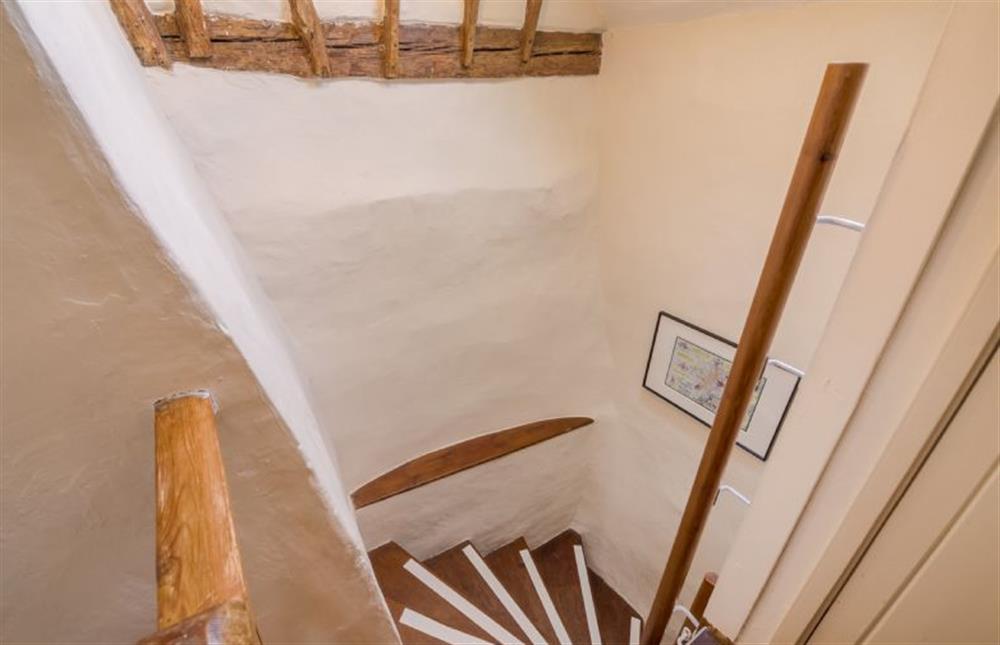 Steep Norfolk winder stairs with hand rail lead to first floor at Brooke Cottage, Great Walsingham