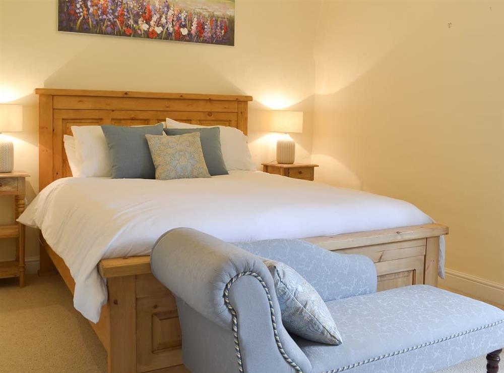 Comfortable double bedroom with chaise longue at Jasmine Cottage, 