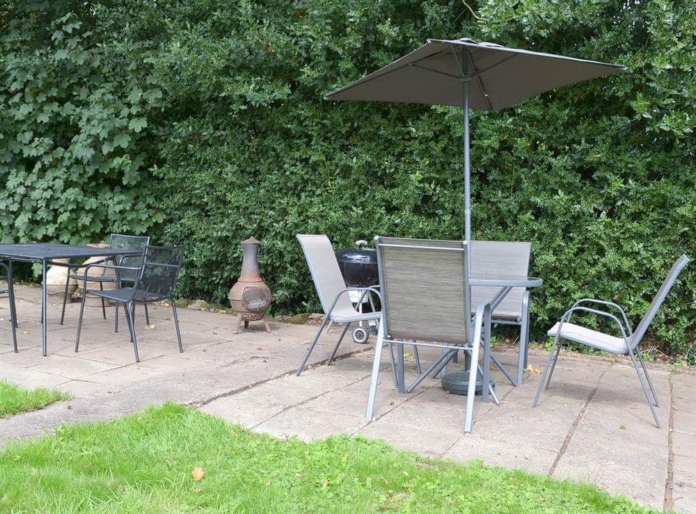Paved patio area with table and chairs at Jasmine Cottage, 