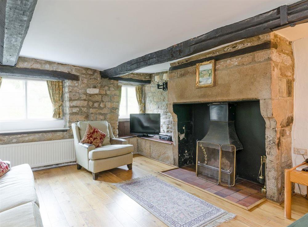 Living room with inglenook fireplace & open fire (photo 2) at Brookside Cottage in Beeley, near Chatsworth, Derbyshire