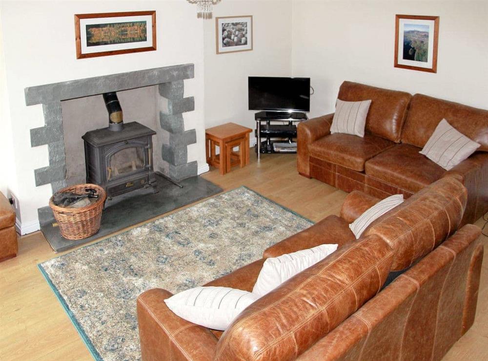 Cosy living room with woodburner at Brookside in Keswick, Cumbria