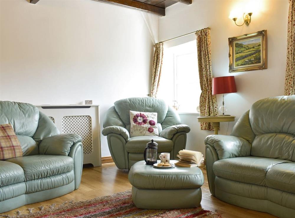 Comfy seating area within living room at Brookside in Langthwaite, near Reeth, North Yorkshire