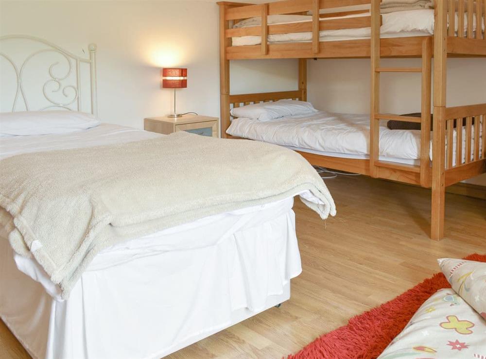 Multi-sleep bedroom with a single and bunk beds at Brookside in Langthwaite, near Reeth, North Yorkshire