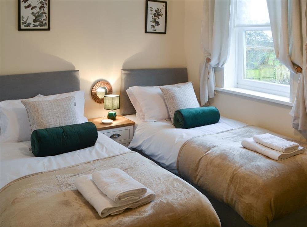 Charming bedroom with twin single beds at Broughs House in North Broomhill, near Amble, Northumberland