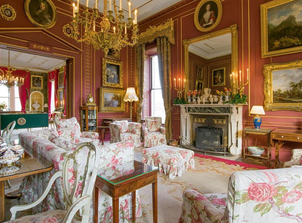 The red drawing room adjoins the green drawing room at Broughton Hall in Broughton, near Skipton, North Yorkshire