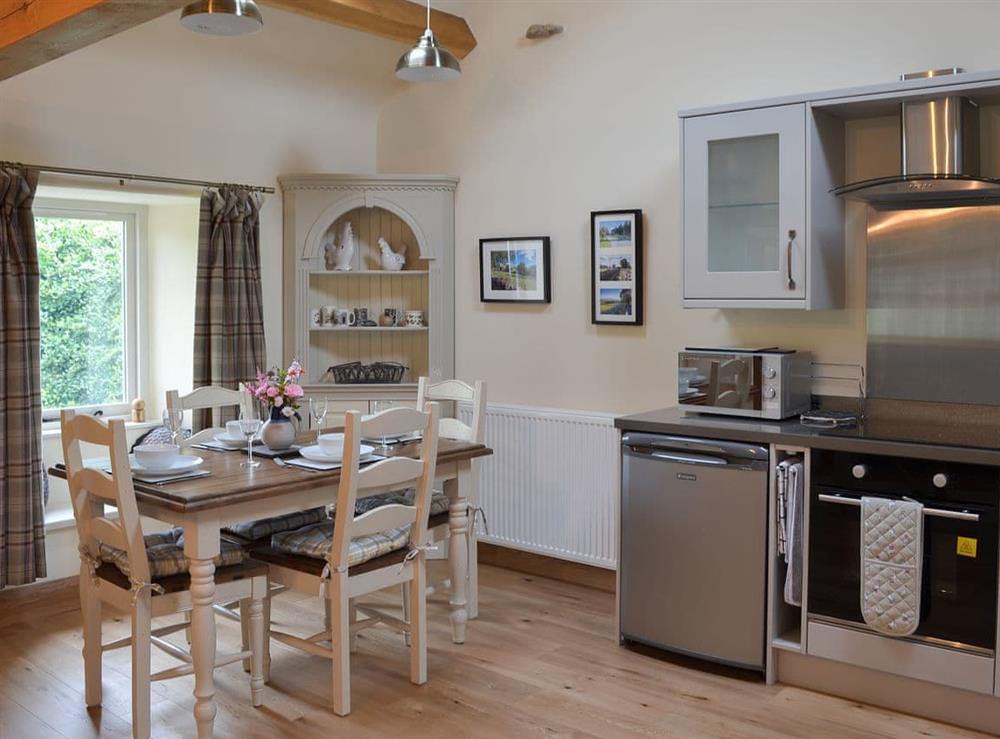 Elegant dining area and adjacent kitchen at Brow View Cottage in Ravenstonedale, near Kirkby Stephen, Cumbria