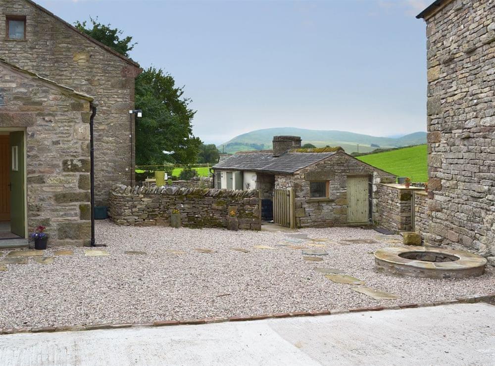 Gravelled courtyard with covered well at Brow View Cottage in Ravenstonedale, near Kirkby Stephen, Cumbria