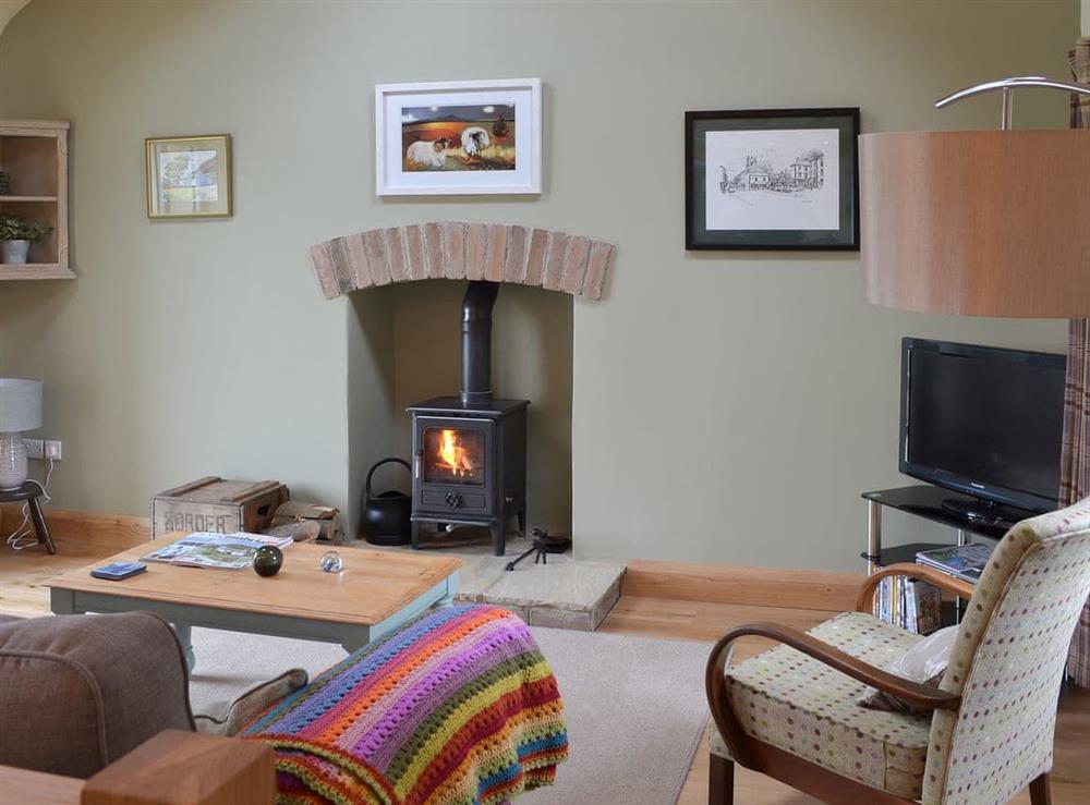 Living area with cosy wood burner at Brow View Cottage in Ravenstonedale, near Kirkby Stephen, Cumbria