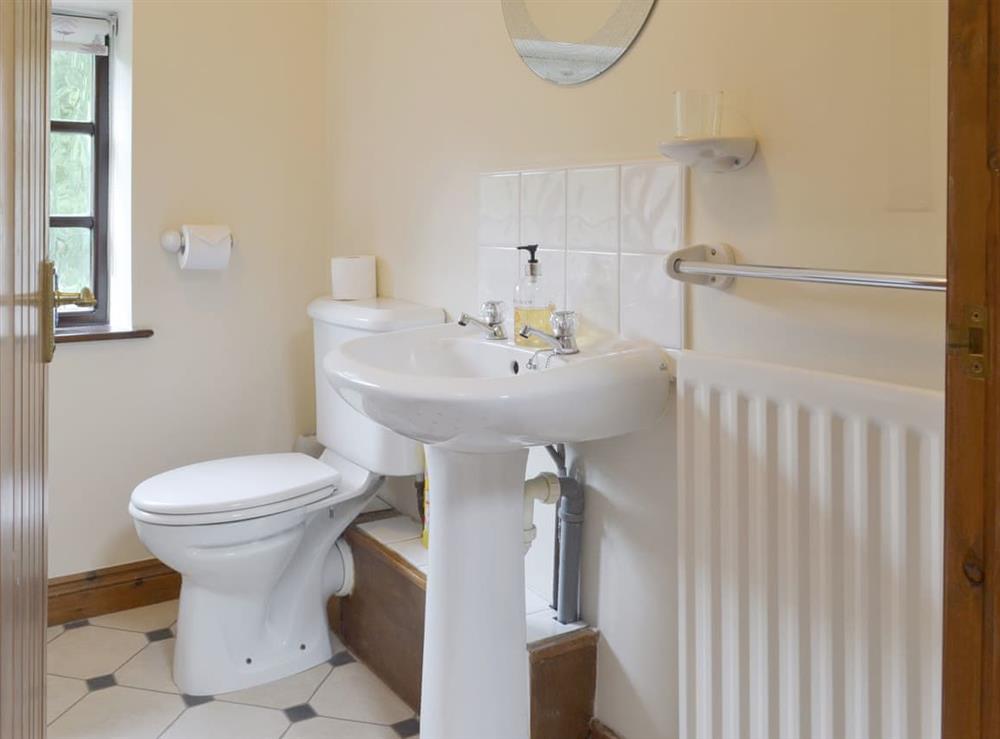 Bathroom with shower over bath at Bluebell Cottage, 
