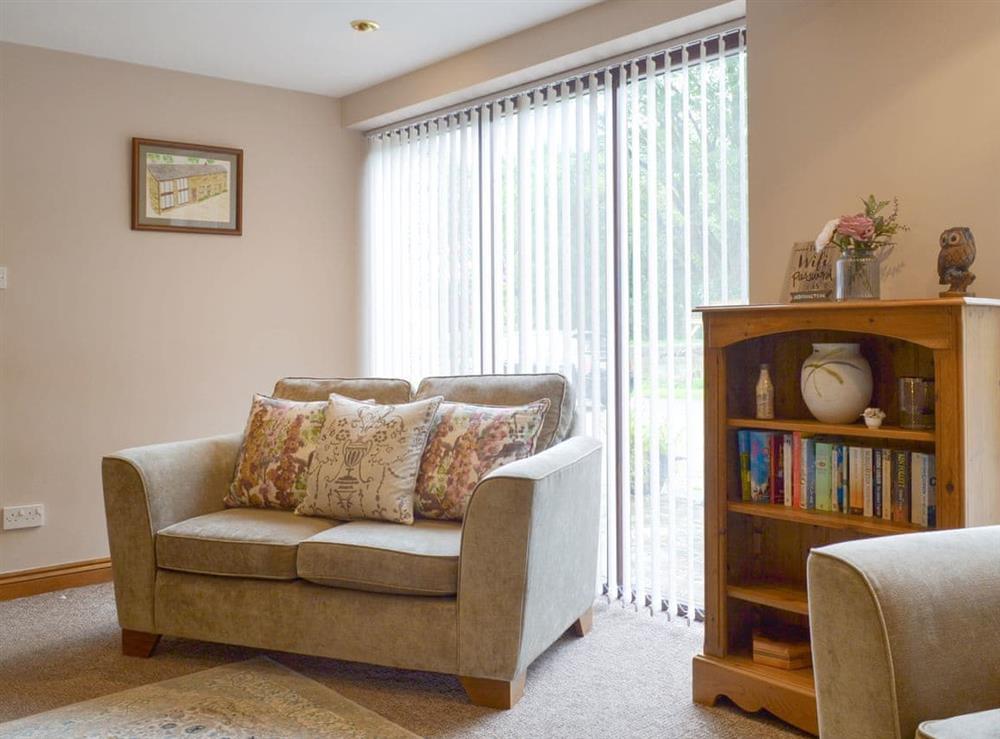 Comfortable seating within living area at Lilly Cottage, 