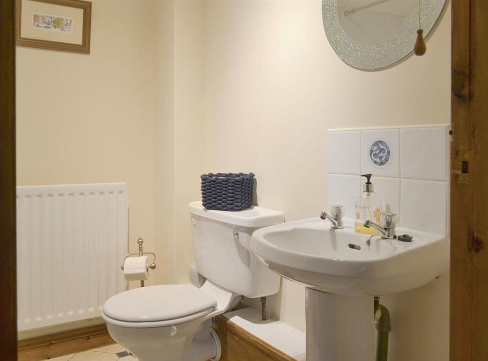 Family bathroom with shower over bath at Lilly Cottage, 