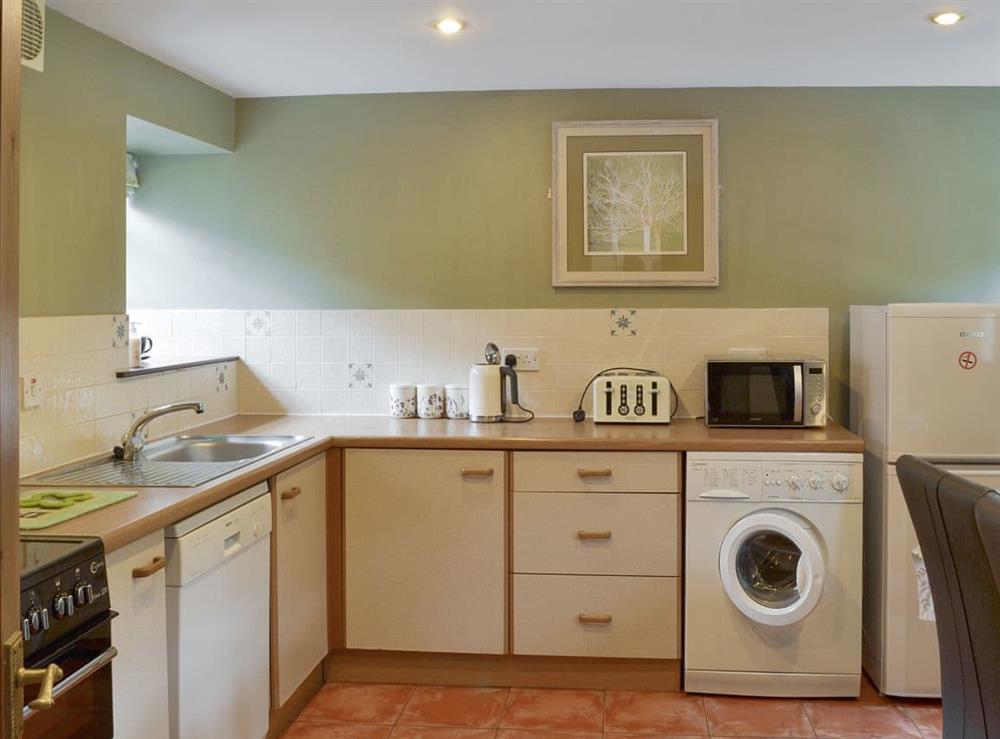 Spacious kitchen with dining area at Lilly Cottage, 